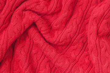 Handmade knitwear, background, knitted texture with a pattern, bright red color