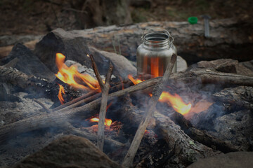 Heating water on a kettle on a campfire