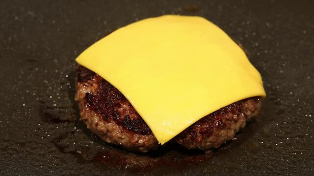Broiling beef burger with cheddar cheese