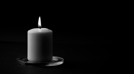 Obraz na płótnie Canvas burning candle isolated with black background, Space for text. (black and white).
