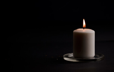 burning candle isolated with black background. Space for text.