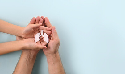 World Pneumonia Day or world tuberculosis day, copd. Adult and child hands holding lung. Concept...