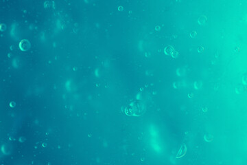 Texture of transparent mint antiseptic gel with air bubbles on light blue monochrome background. Concept of skin moisturizing and prevention of virus. Liquid beauty product closeup. Backdrop, flat lay