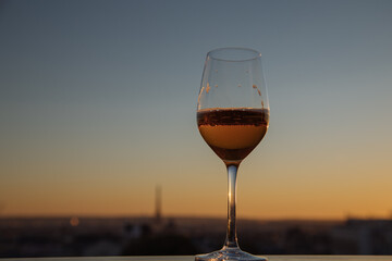 glass of rose wine on the balcony with the Eiffel Tower in the distance 