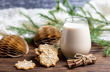 Eggnog traditional Christmas drink with cinnamon and ginger cookies. Cookies and milk for Santa Claus
