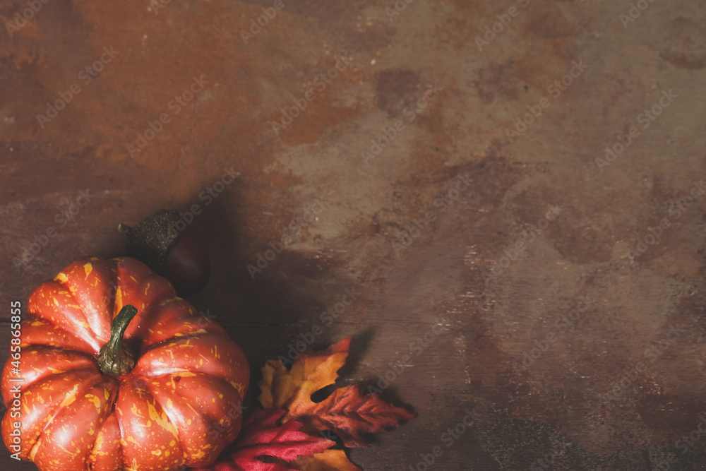 Sticker autumn season pumpkin on brown texture background with copy space for thanksgiving holiday during fa