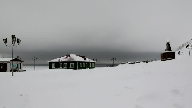 BARENTSBURG, SVALBARD 25 APRIL, 2013: Landscape and buildings in Russian Arctic mine village of Barentsburg on coast of Arctic Ocean on Svalbard. Coal mines.