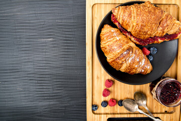 croissant and raspberry jam for breakfast.