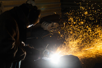 employee performs welding work. Welding or gas welding and oxy-fuel cutting are processes that use...