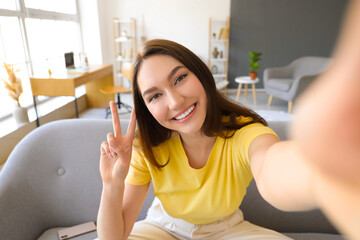 Beautiful happy woman taking selfie at home - obrazy, fototapety, plakaty
