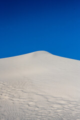 Fototapeta na wymiar White Dune Peak and Deep Blue Sky