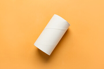 Empty toilet paper tube on color background