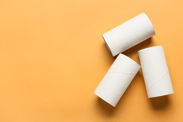 Empty toilet paper tubes on color background