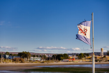 Flag of the Argentine Welsh colony flies frayed in Puerto Madryn, Argentina