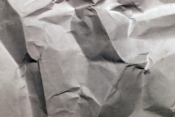 Contrasting grey crumpled paper with textured folds close-up