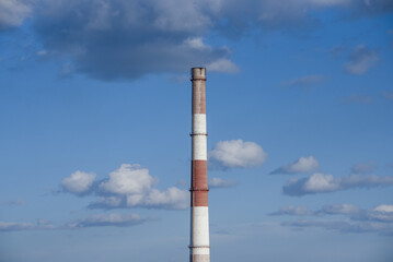 close-up factory brick chimney. pipe cogeneration plant on the sky background. Ambient air pollution industrial emissions