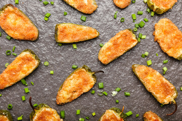 Tasty jalapeno poppers on color background