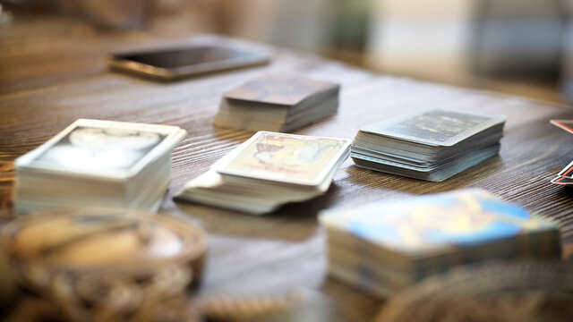 Tarot card reader arranges cards in a card spread. Fortune-telling concept