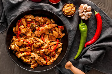 Frying pan with tasty Fajita and sauce on color wooden background