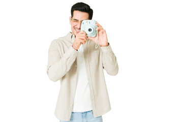 Happy man taking a picture with a colorful camera