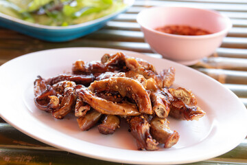 grilled pork intestine on plate, thai food