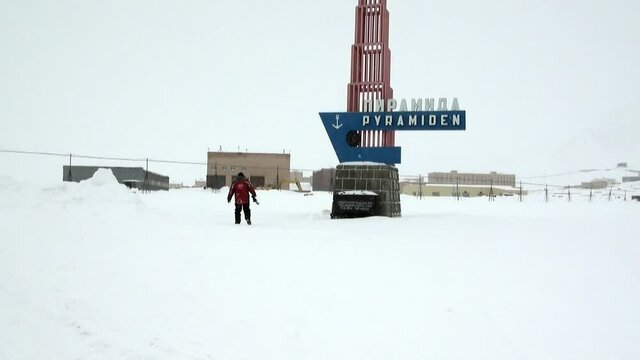 Spitsbergen, Norway-21 April 2011: Man in abandoned city Pyramiden Spitsbergen Arctic. Russian neglected township. Canned place times of Soviet Union. Time stood still of North Pole.