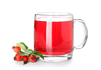Glass cup of tasty rose hip tea and berries on white background