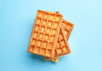 Delicious Belgian waffles on color background