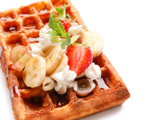 Tasty Belgian Waffle with fruits on white background, closeup