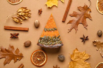 Composition with piece of delicious pumpkin pie on brown background