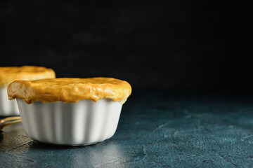 Tasty vegetable pot pie on black background