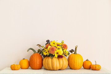 Obraz na płótnie Canvas Beautiful autumn bouquet with pumpkins on light background