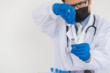 Doctors holding syringes, syringes, and healthcare research workers working in science labs. medical science technology research to test vaccine, vaccine treatment against coronavirus covid-19