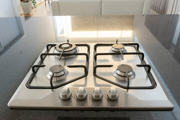 Modern hob gas stove made of stainless steel using natural gas or propane for cooking products on...