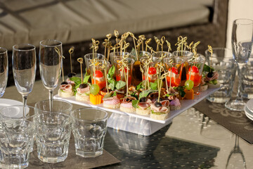 Appetizers on the white plate on a buffet table. High quality photo