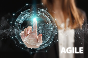 Business, Technology, Internet and network concept. Young businessman working on a virtual screen of the future and sees the inscription: Agile