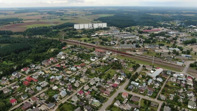 Private house district near railway tracks and industrial buildings in Jonava city, aerial view