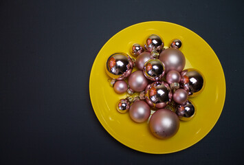 grey background, yellow plate with pink balls