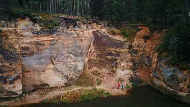 Erglu Cliffs and Great View on the Gauja River Cesis, Latvia. Autumn Landscape Red Rocks Stone Cliff and River  at Gauja National Park. Captured From Above With a Drone. Aerial Shot 4K.