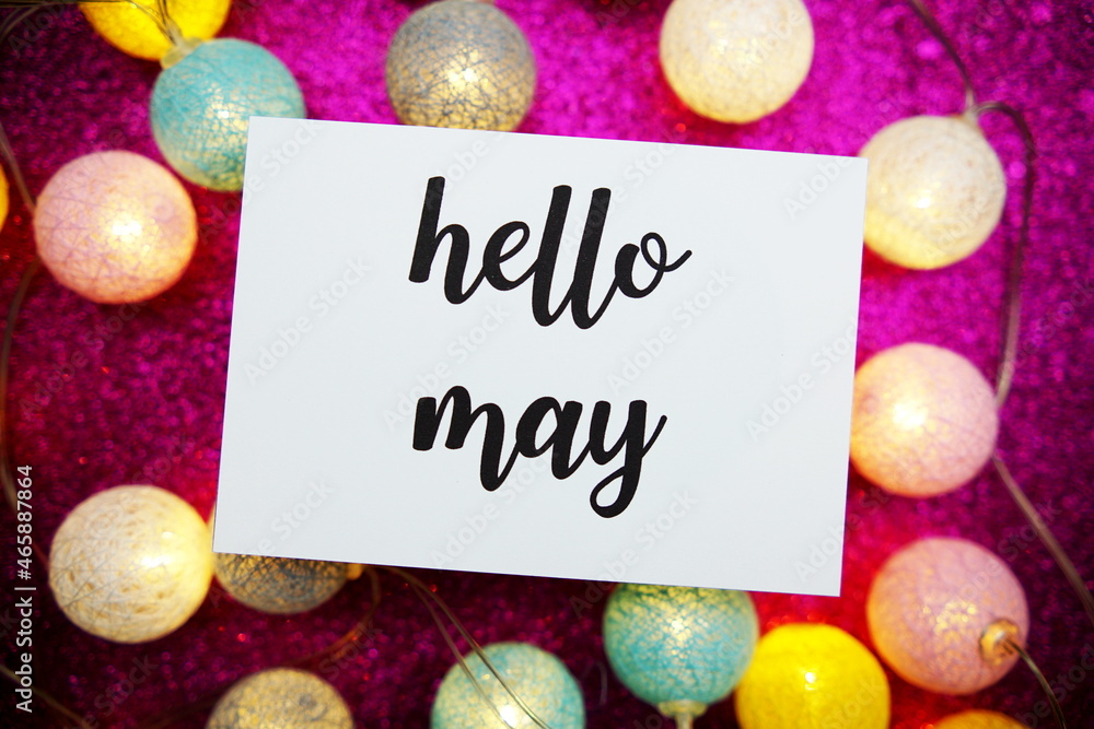 Aufkleber hello may text on paper card top view on pink bokeh background