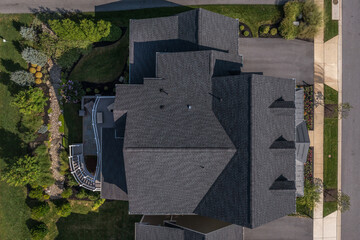 Aerial top down view of a complex hip and valley pitched roof  with three dormers on a new...