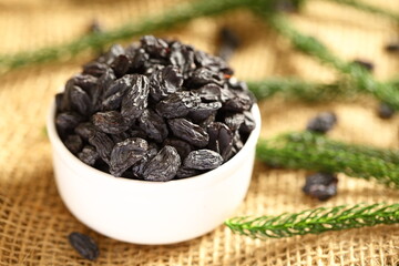 Bowl of sun dried organic black raisins.