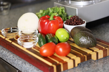 Ingredients for avocado and black bean salsa, garnished with Mandarin oranges and cilantro. 