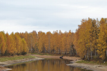 Fototapeta na wymiar Shallow forest river, reflection, autumn landscape.