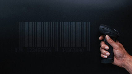 Barcode scanning. Reader laser scanner for warehouse. Retail label barcode scan on dark background. Warehouse inventory management.