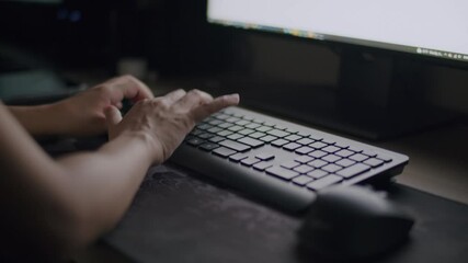 Close-Up hand typing keyboard of businesswoman staying late hours in the home office concentrating on her work sitting with a computer.