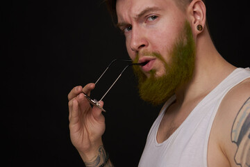 bearded man in white t-shirt with tattoos on his arms posing bully
