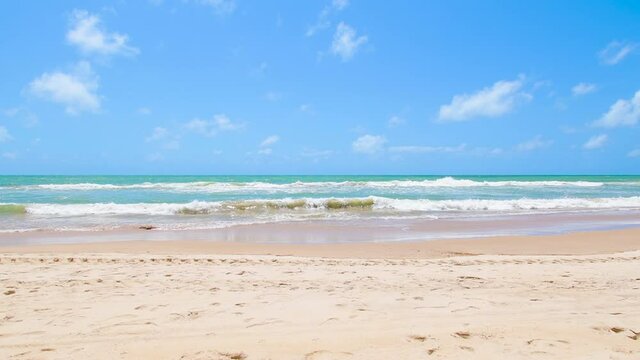 Beautiful day at the beach, light sand, green tones sea and a blue sky day. Video of the beach of Boa Viagem at the coastal city of Recife, PE, Brazil. Northeast brazilian beach.
