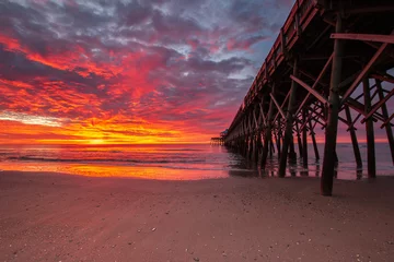 Fotobehang fiery sunrise at the beach pier © The Camera Queen 