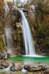 Fototapeta na wymiar Waterfall and fall colors in Italy.